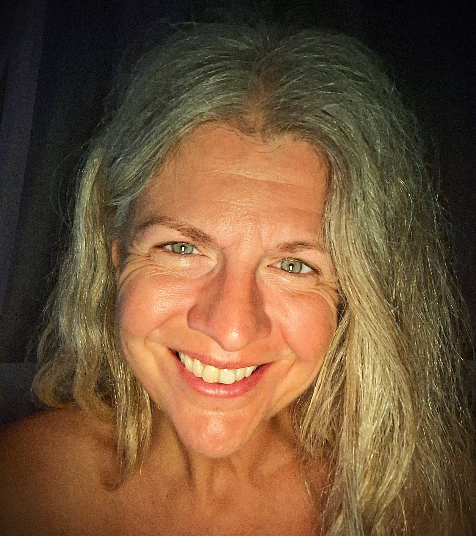 Dove, smiling, with long silver hair